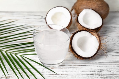 Glass of coconut water on wooden table