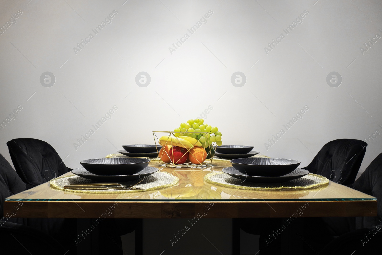 Photo of Table set for dinner near white wall