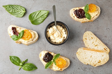 Tasty fresh tomato bruschettas on grey table, flat lay