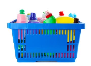 Shopping basket full of detergents on white background