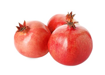 Photo of Many fresh ripe pomegranates isolated on white