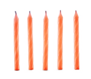 Thin orange birthday candles isolated on white