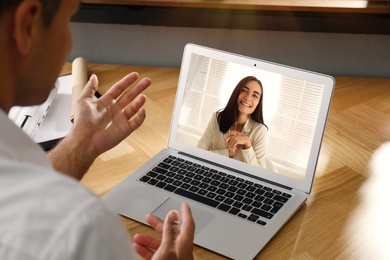Image of Coworkers working together online. Man using video chat on laptop, closeup