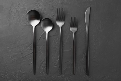 Photo of Beautiful cutlery set on black table, flat lay