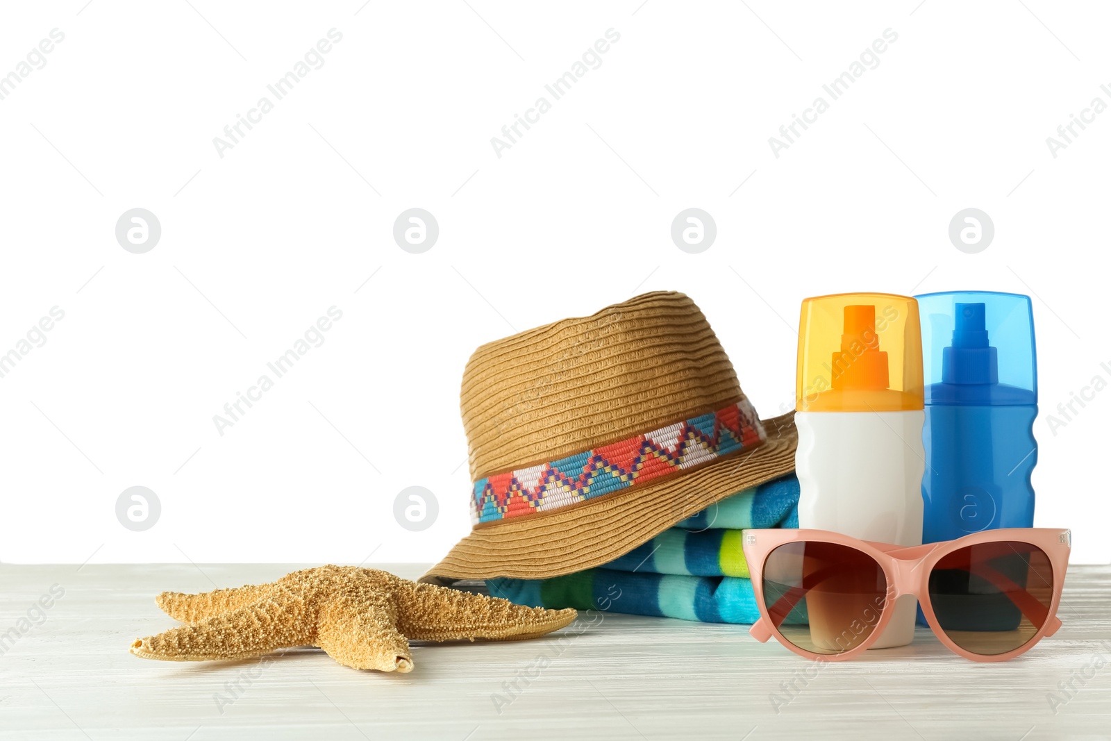 Photo of Set of beach accessories on table against white background. Space for text