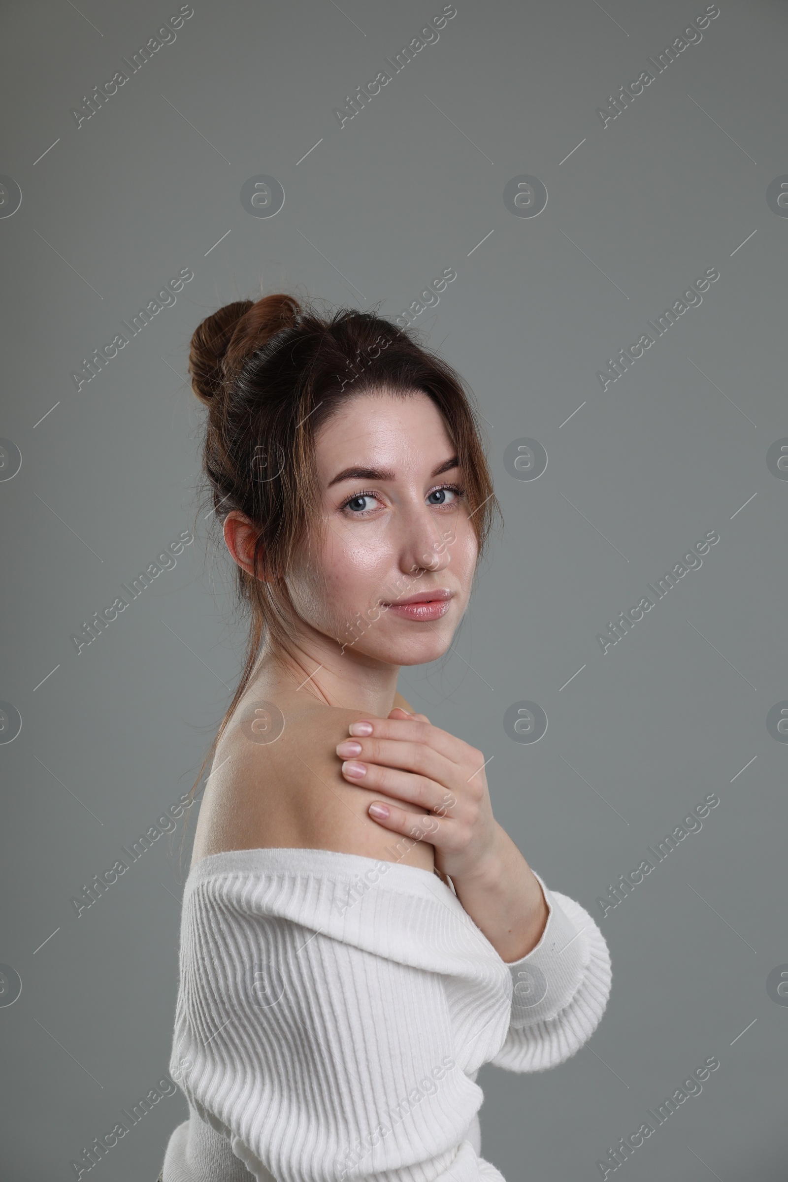 Photo of Portrait of beautiful young woman on grey background