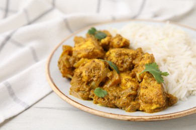 Photo of Delicious chicken curry with rice on table, closeup