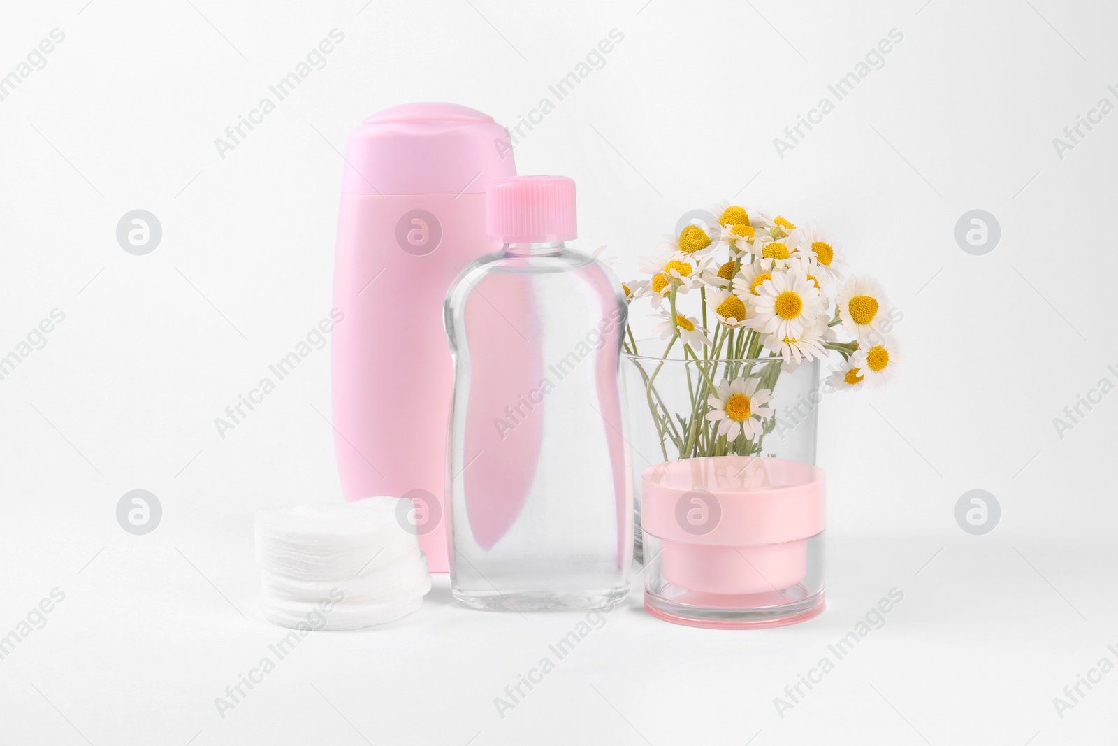 Photo of Different skin care products for baby and daisies on white background