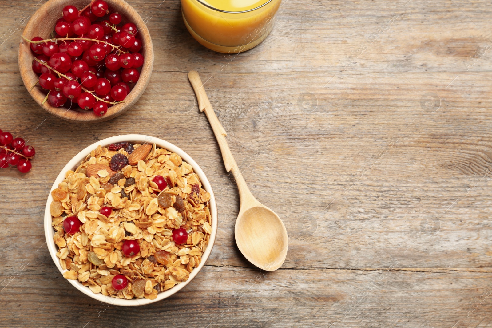 Photo of Flat lay composition with muesli on wooden table, space for text. Delicious breakfast