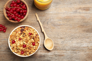 Photo of Flat lay composition with muesli on wooden table, space for text. Delicious breakfast