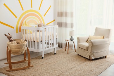 Baby room interior with crib near decorated wall