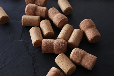 Photo of Many wine bottle corks on black table