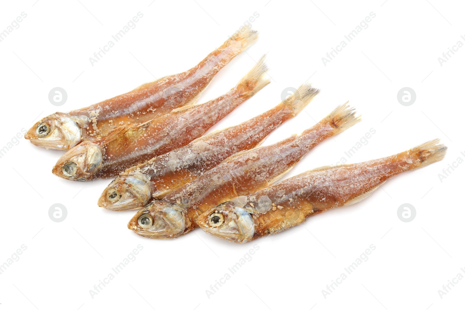 Photo of Delicious dried salted anchovies on white background