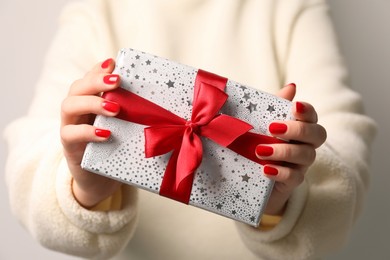 Christmas present. Woman holding gift box, closeup