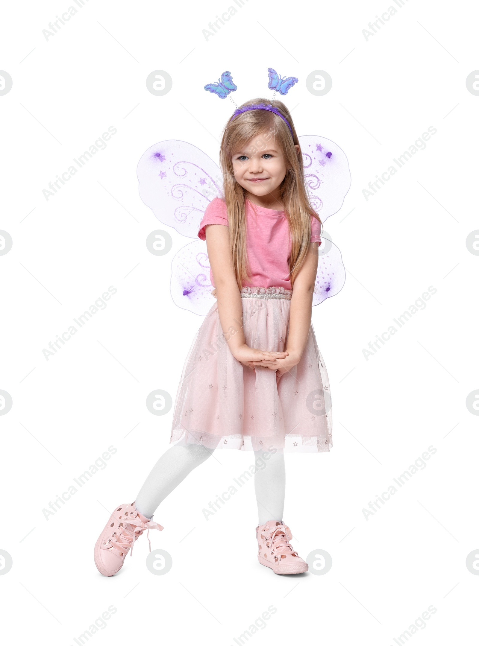 Photo of Cute little girl in fairy costume with violet wings on white background