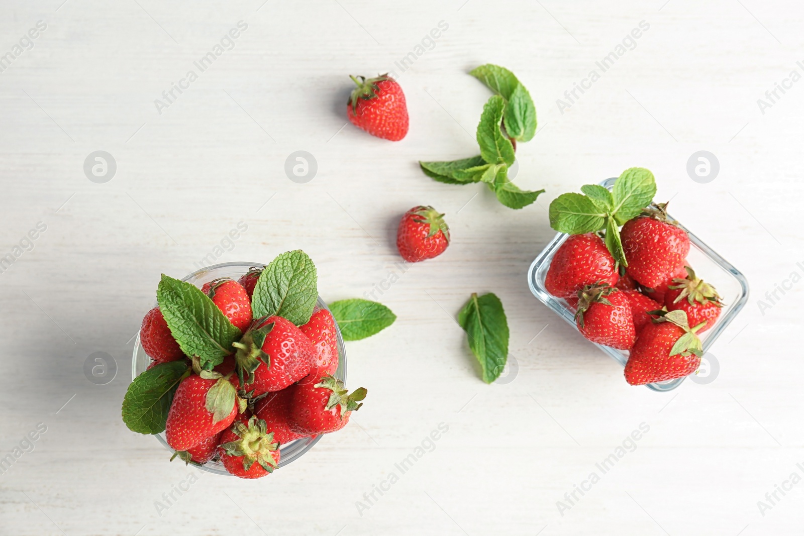 Photo of Flat lay composition with ripe red strawberries and mint on light background