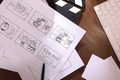 Storyboard with cartoon sketches at workplace, flat lay. Pre-production process