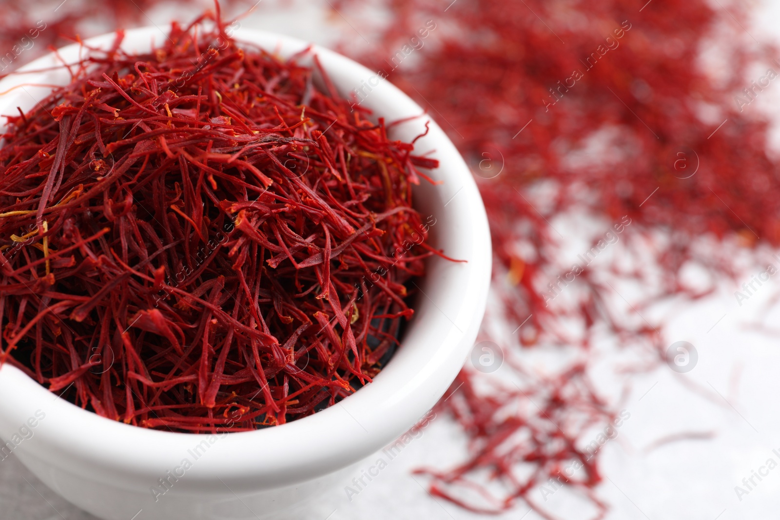 Photo of Dried saffron on grey table, closeup. Space for text