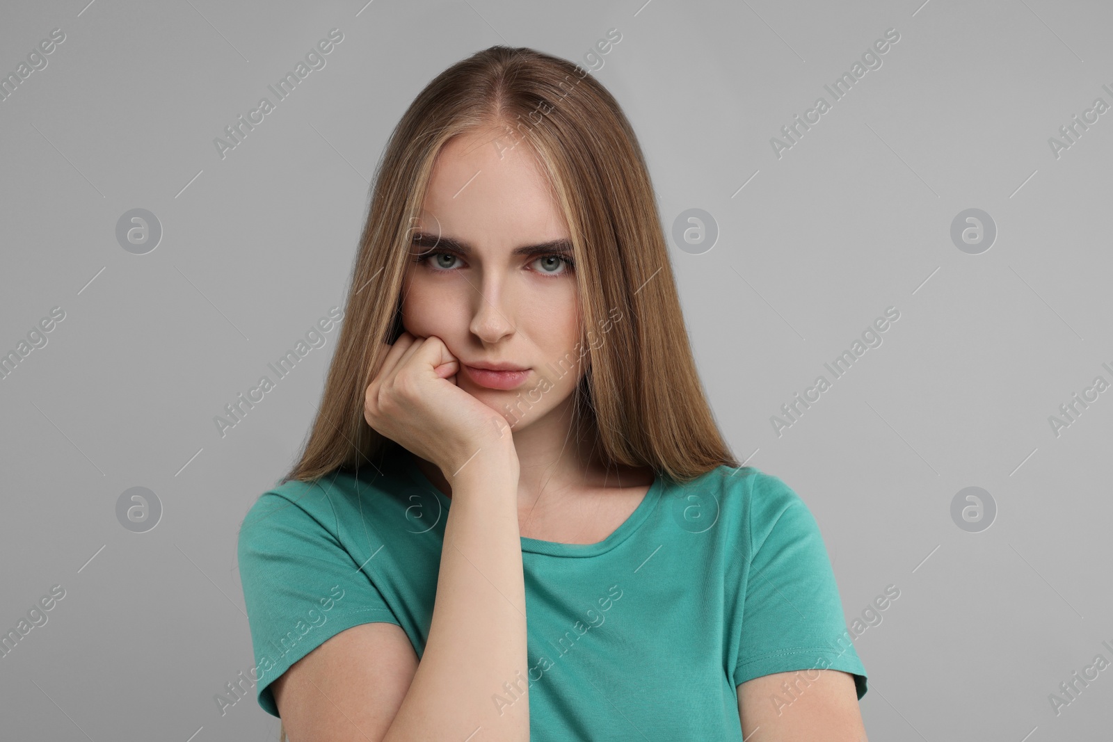 Photo of Portrait of resentful woman on grey background
