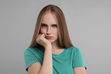 Photo of Portrait of resentful woman on grey background