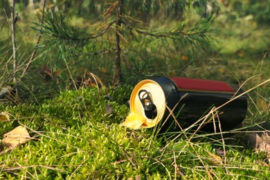 Photo of Used aluminium can on green grass outdoors. Recycling problem