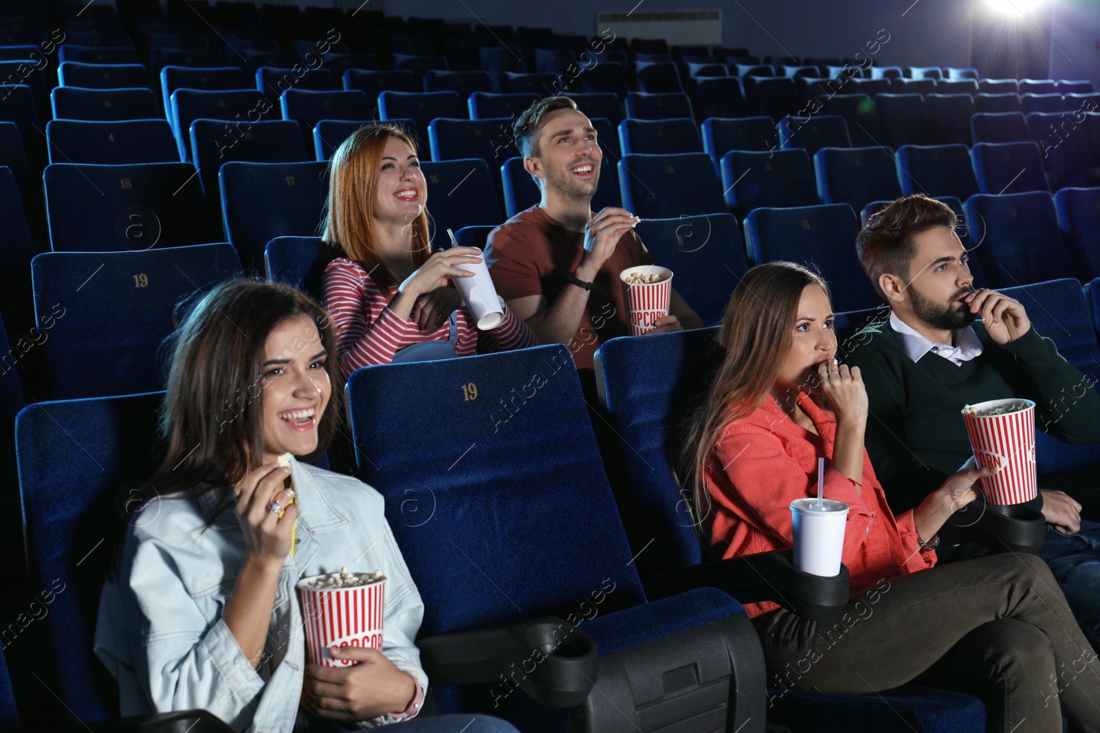 Photo of Young people watching movie in cinema theatre