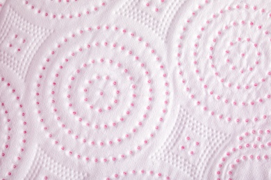 Photo of Toilet paper with pattern as background, closeup