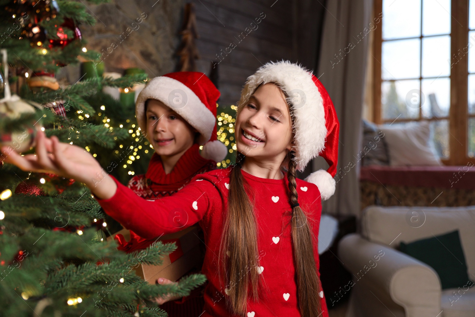 Photo of Happy children near beautiful Christmas tree at home