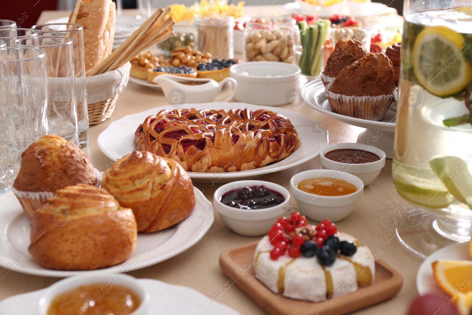 Photo of Variety of snacks on wooden table in buffet style