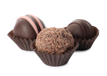 Many different delicious chocolate truffles on white background