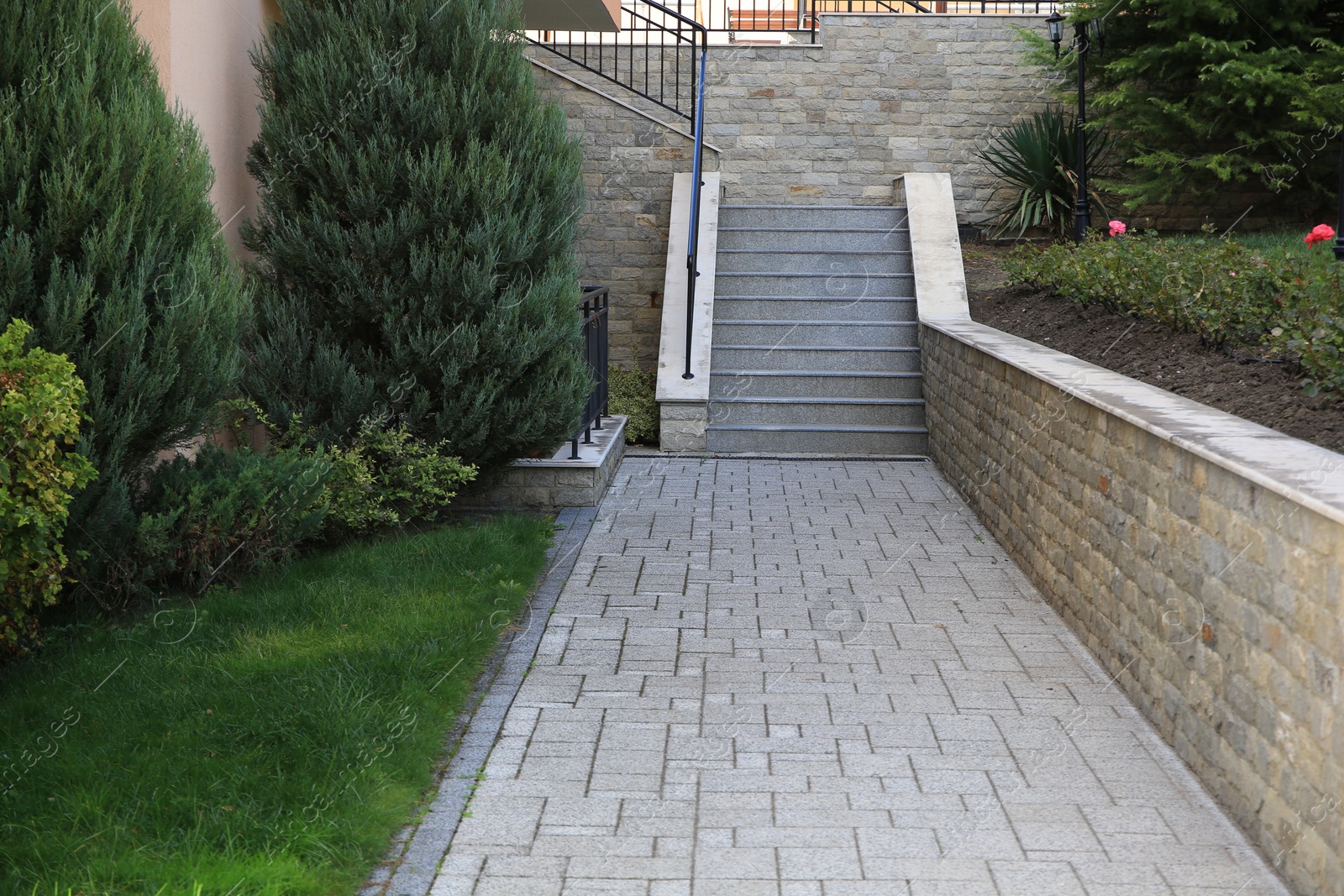 Photo of Beautiful concrete stairs near trees and paved pathway