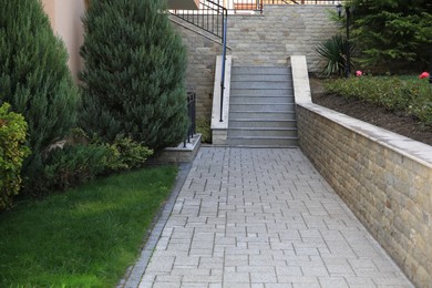 Beautiful concrete stairs near trees and paved pathway