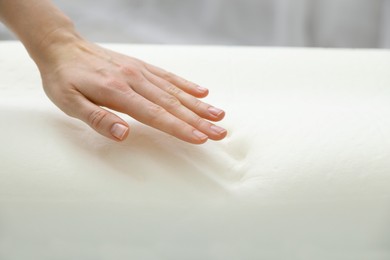 Photo of Woman with memory foam pillow indoors, closeup. Space for text