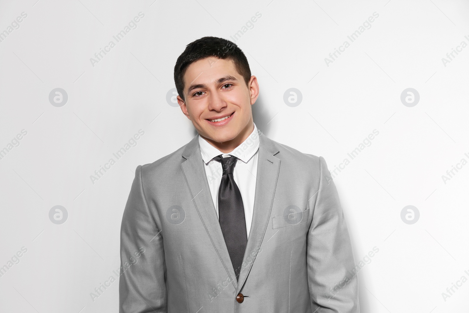 Photo of Portrait of young businessman on light background