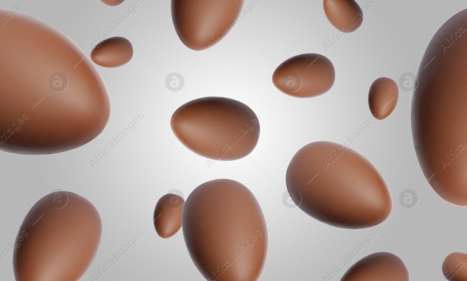 Image of Many chocolate eggs falling on light grey background