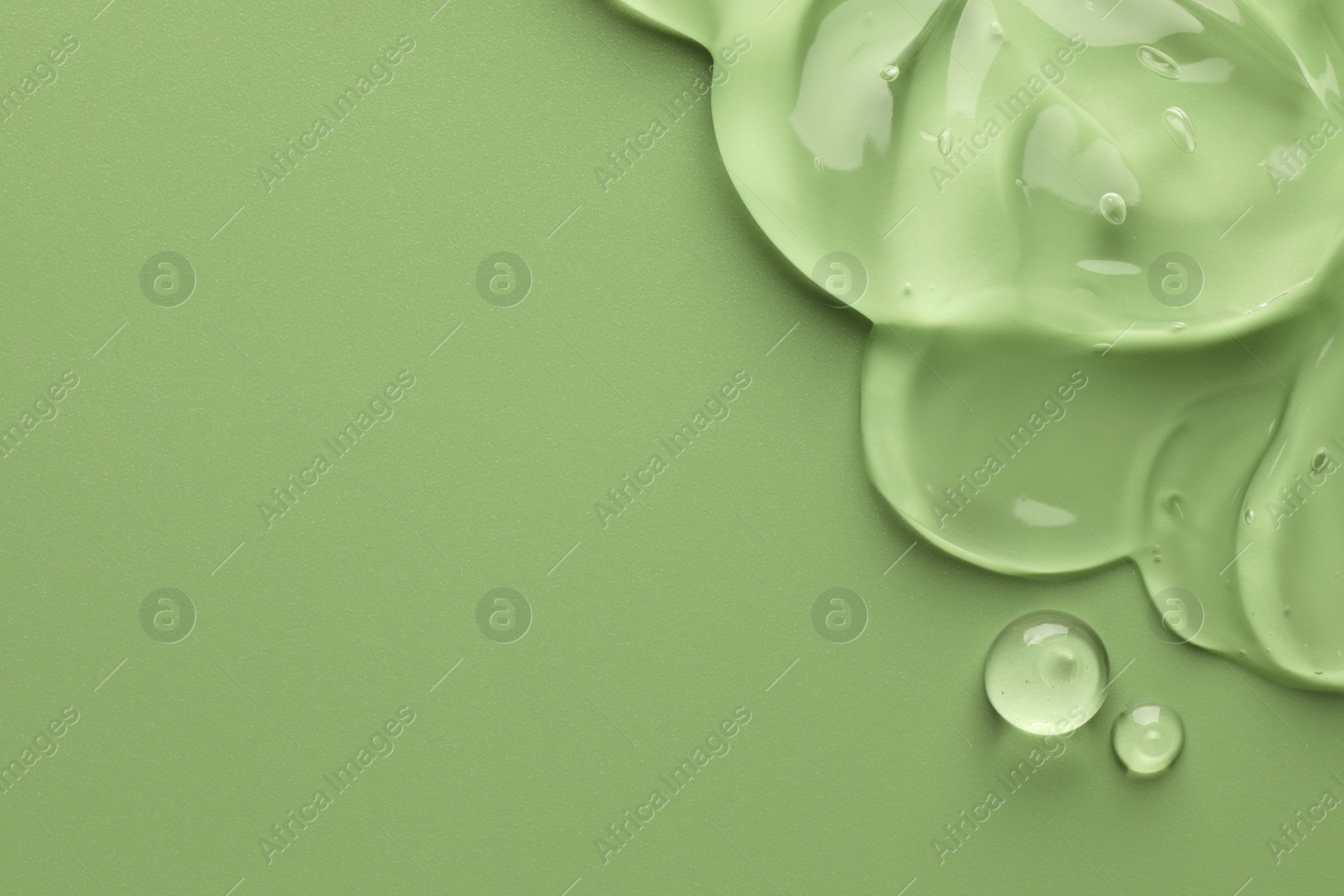 Photo of Clear cosmetic gel on light green background, top view. Space for text