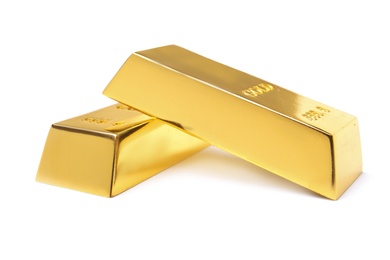 Photo of Precious shiny gold bars on white background