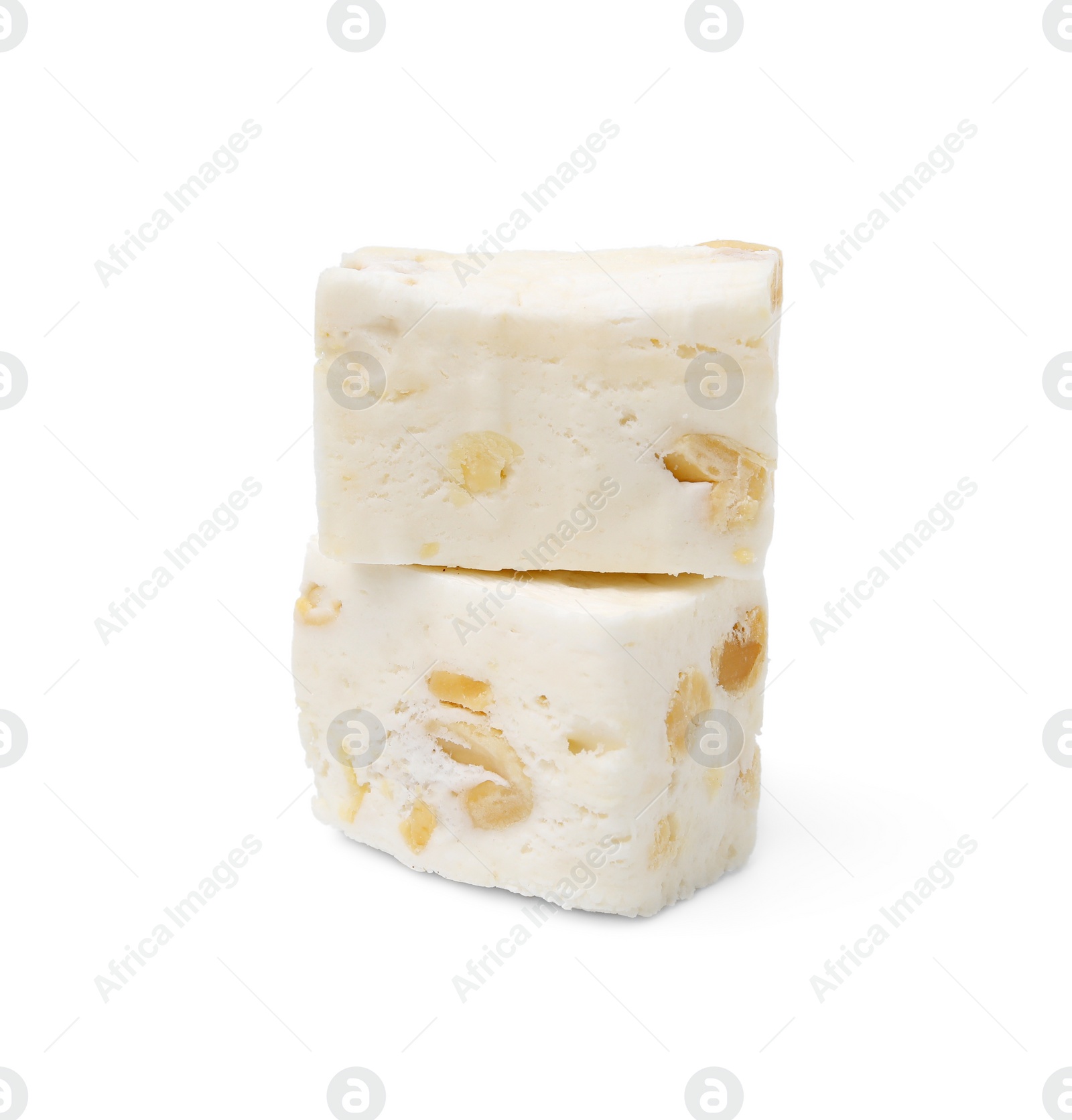 Photo of Pieces of delicious nougat on white background