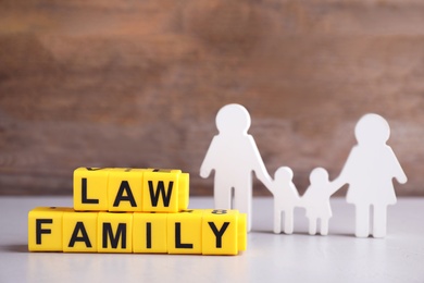 Photo of Figure in shape of people and cubes with words Family Law on light table