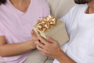 Photo of Lovely couple with beautiful gift, closeup view