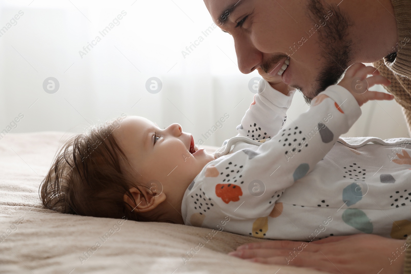 Photo of Father playing with his daughter at home