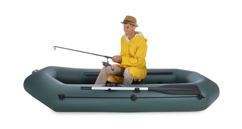 Photo of Man fishing with rod from inflatable rubber boat on white background