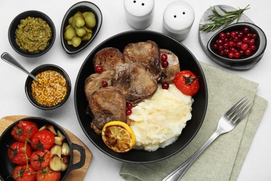 Tasty beef tongue pieces, berries, mashed potatoes and ingredients on white table, flat lay