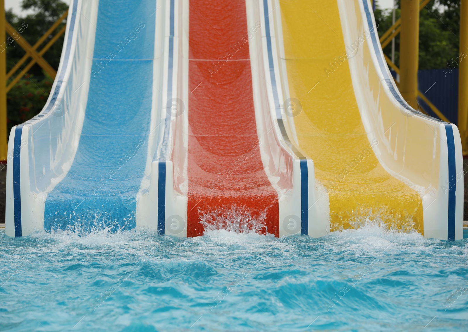 Photo of Colorful slides near swimming pool in water park