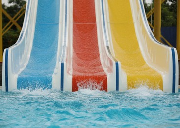 Photo of Colorful slides near swimming pool in water park