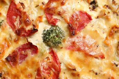 Photo of Tasty quiche with cheese and tomatoes as background, top view