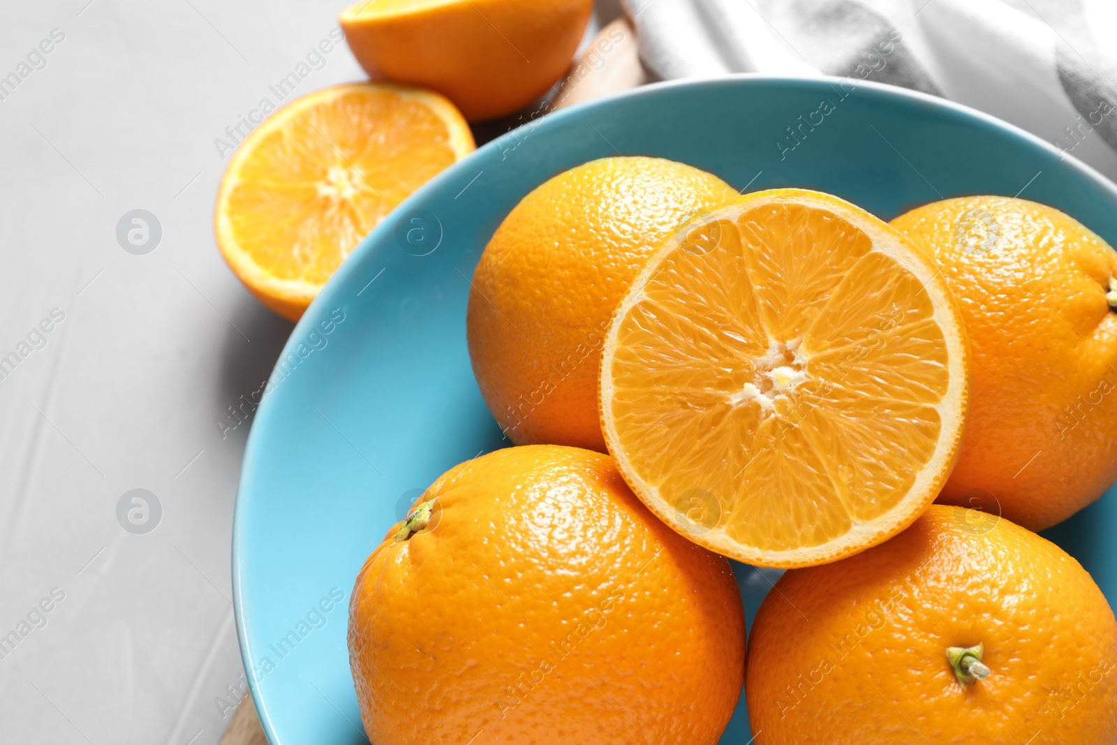 Photo of Plate with fresh ripe oranges on table, above view