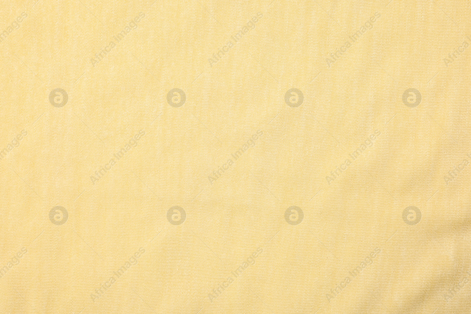 Photo of Texture of soft yellow fabric as background, top view