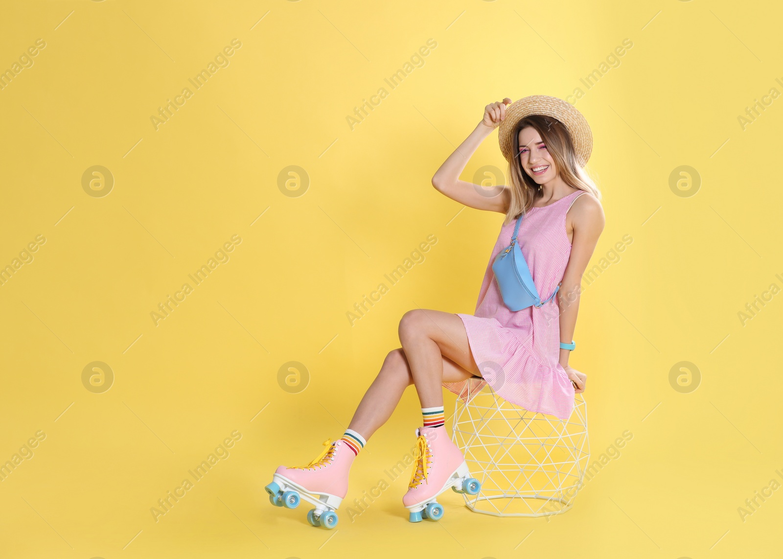 Photo of Young woman with retro roller skates on color background, space for text
