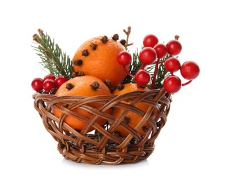 Christmas composition with tangerine pomander balls in wicker bowl isolated on white